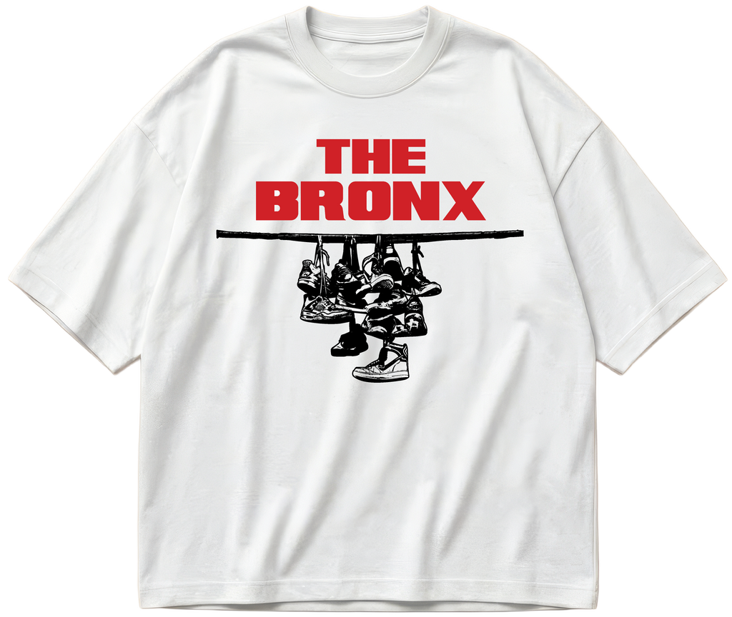 White oversized Sneaker Hang tee with red The Bronx lettering above a black hanging-sneakers design.