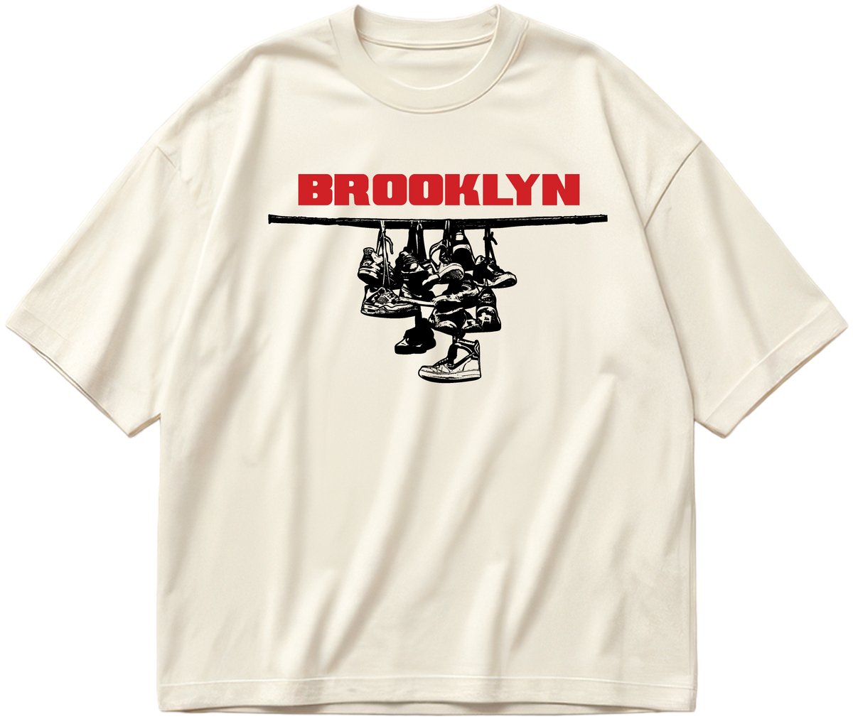 Off-white oversized Sneaker Hang tee with red Brooklyn lettering above a black hanging-sneakers design