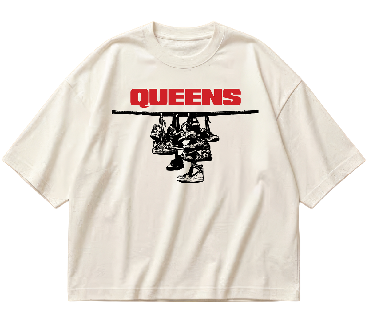 Off-white boxy cropped Sneaker Hang tee with red Queens lettering above a black hanging-sneakers design.