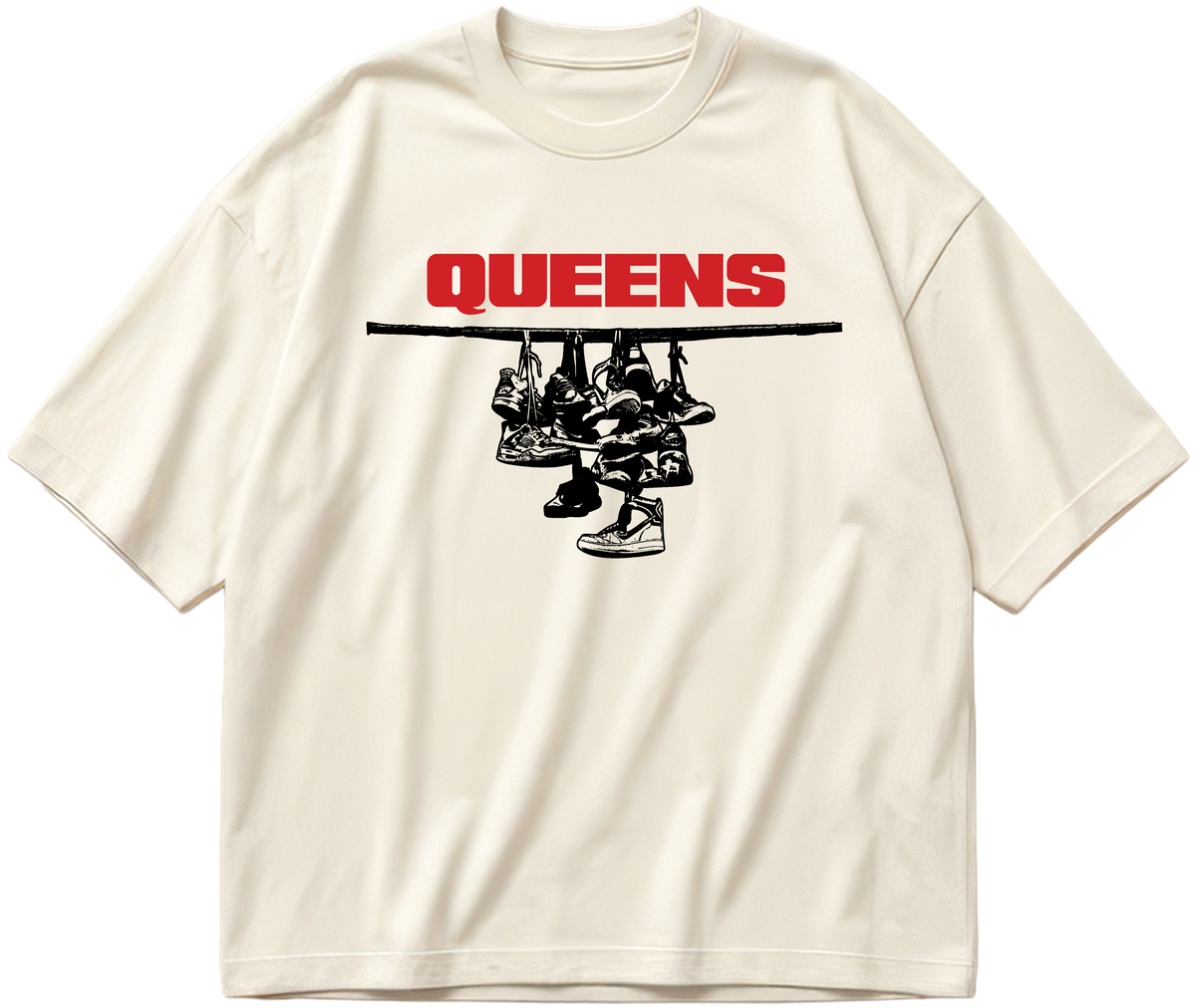Off-white oversized Sneaker Hang tee with red Queens lettering above a black hanging-sneakers design.