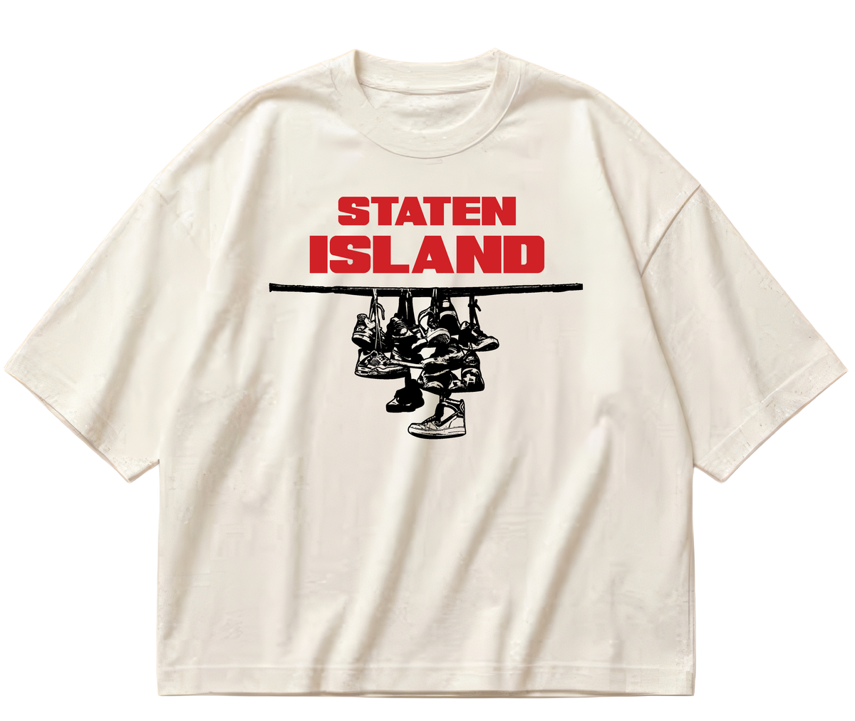 Off-white boxy cropped Sneaker Hang tee with red Staten Island lettering above a black hanging-sneakers design