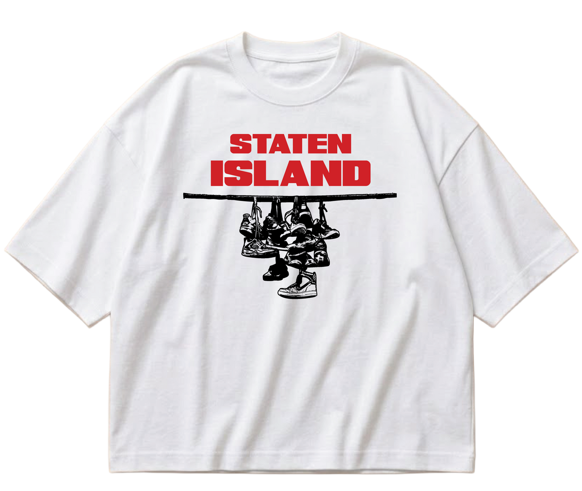 White boxy cropped Sneaker Hang tee with red Staten Island lettering above a black hanging-sneakers design